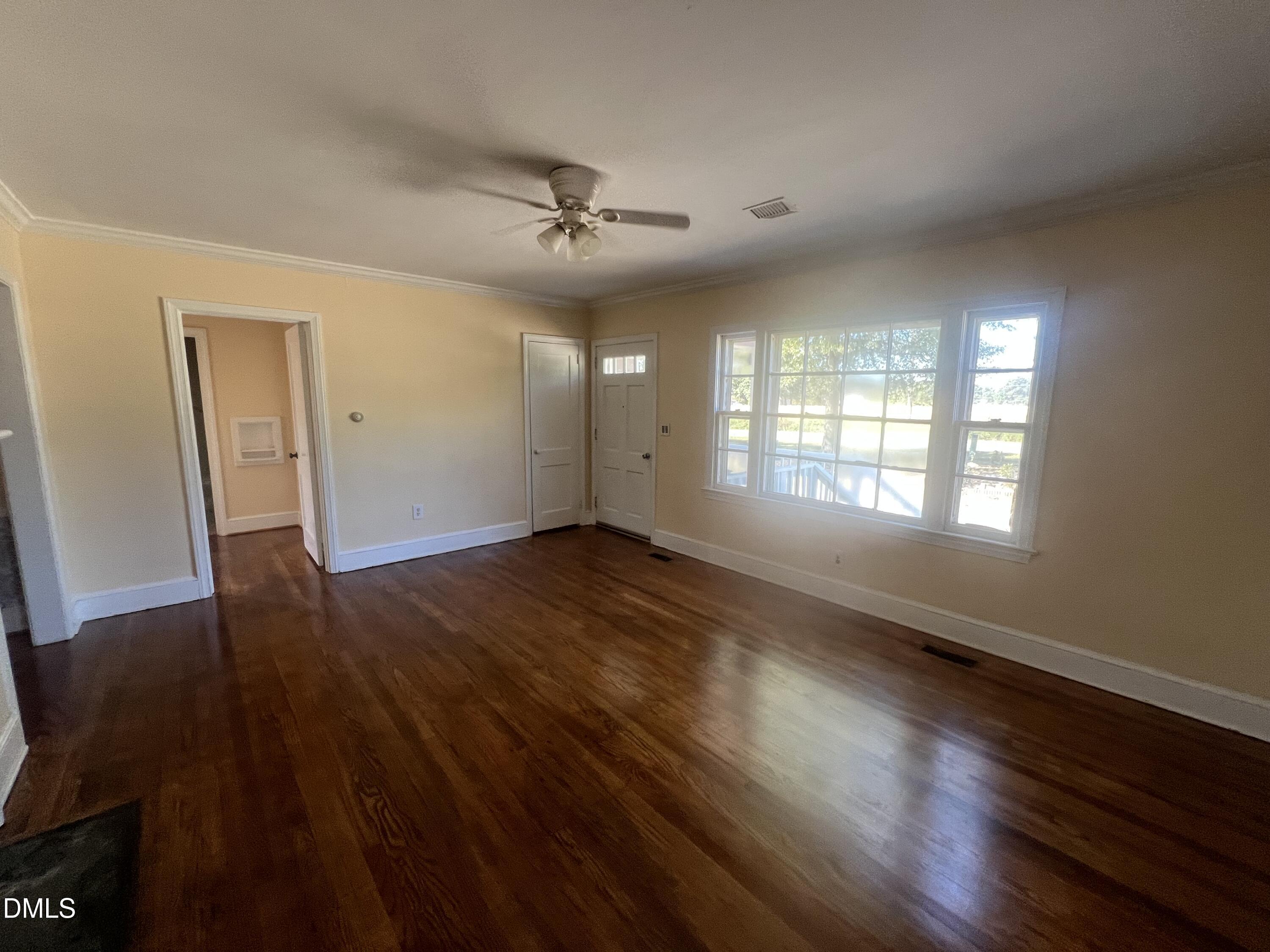 122 Bill Avery Road Coats, NC 27521 - Photo 41 of 51 a view of an empty room with wooden floor and a window