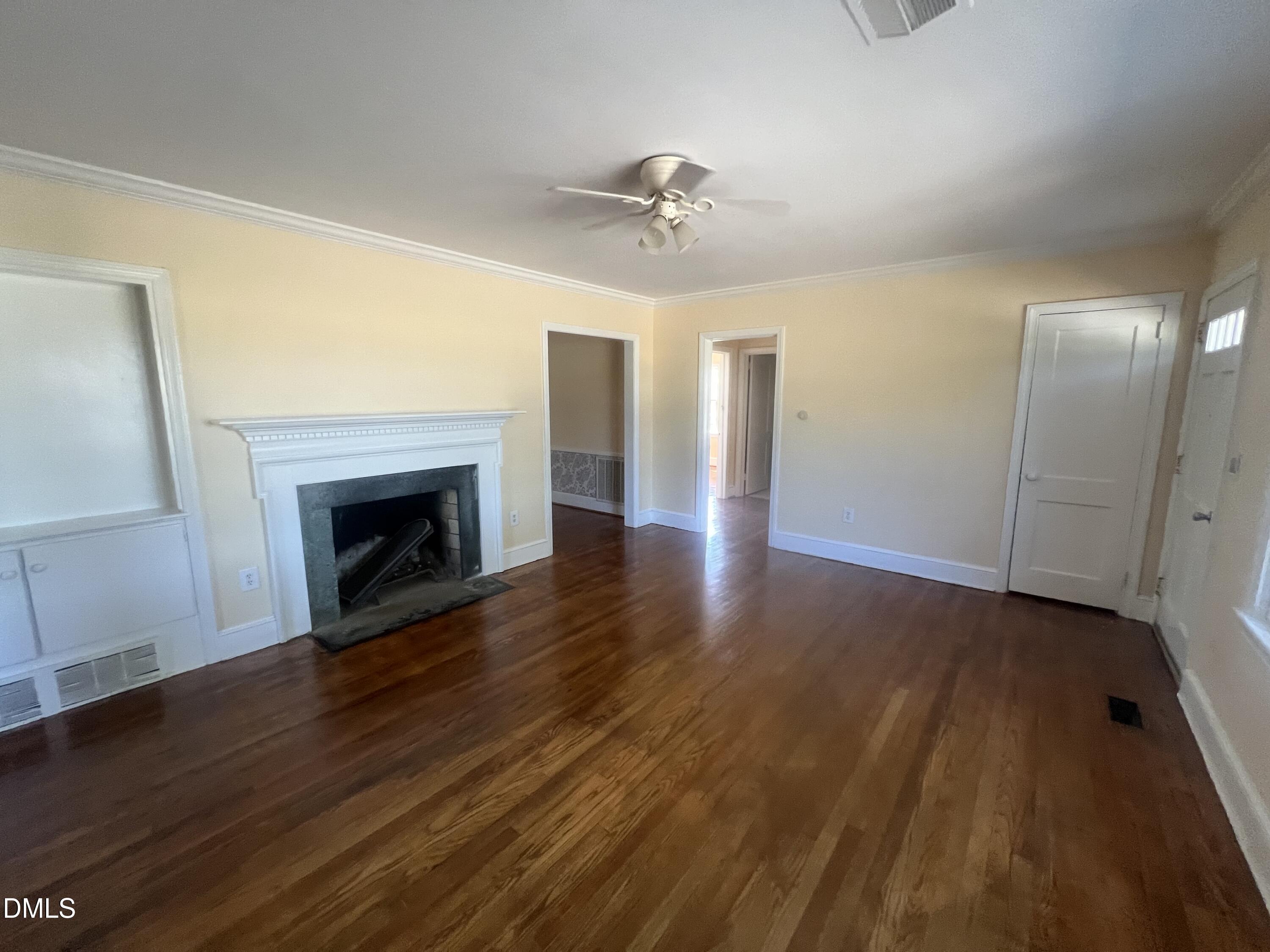 122 Bill Avery Road Coats, NC 27521 - Photo 42 of 51 a view of an empty room with wooden floor fireplace and a window