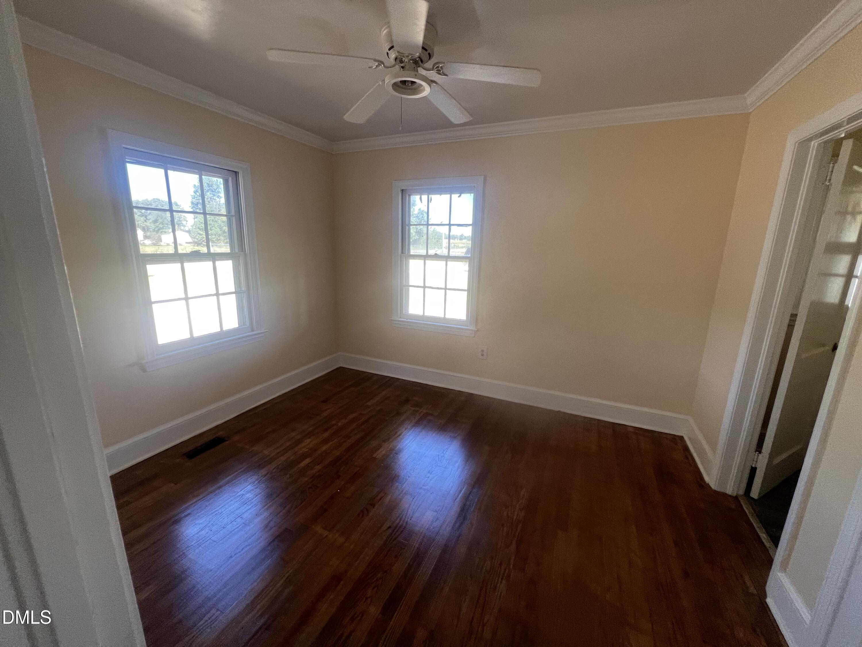 122 Bill Avery Road Coats, NC 27521 - Photo 43 of 51 an empty room with wooden floor and windows
