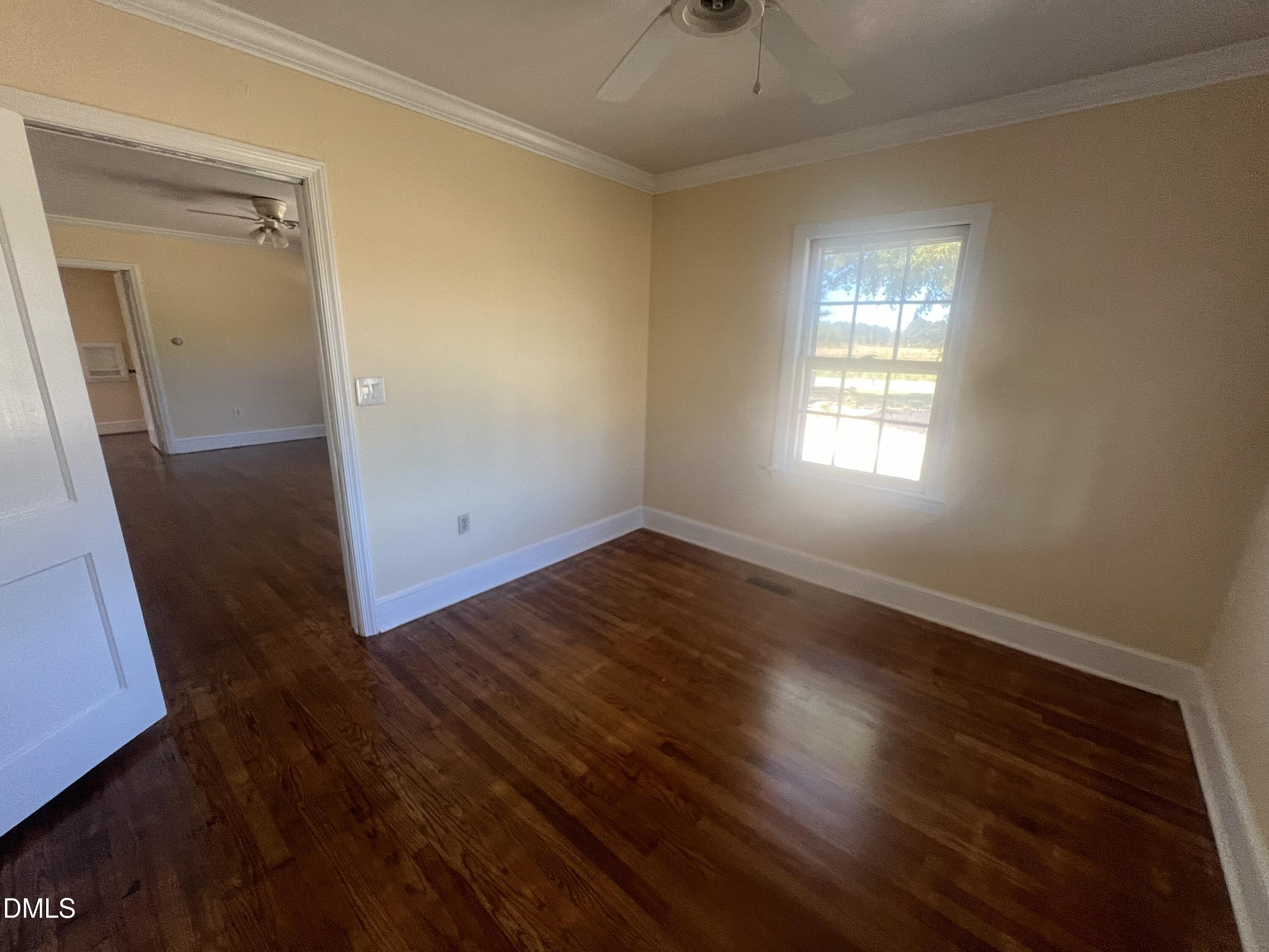 122 Bill Avery Road Coats, NC 27521 - Photo 45 of 51 an empty room with wooden floor and windows