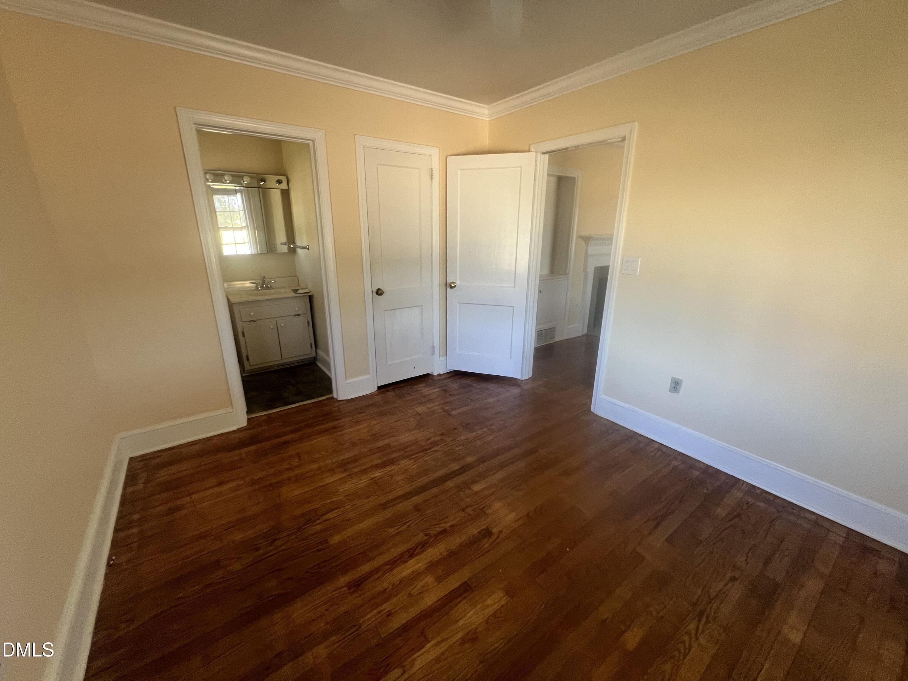 122 Bill Avery Road Coats, NC 27521 - Photo 46 of 51 an empty room with wooden floor and mirror