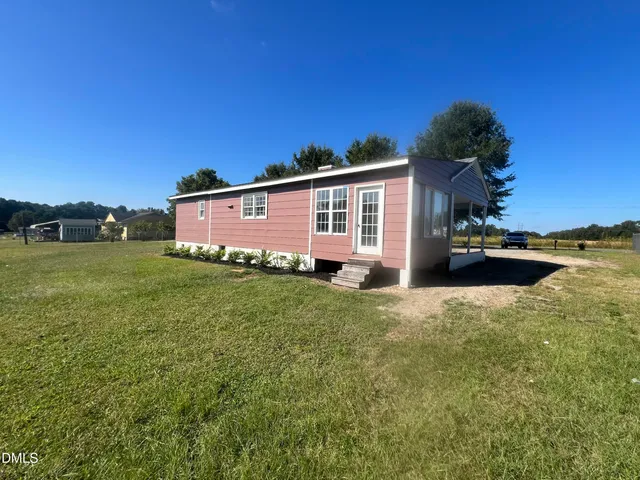 a front view of house with yard and trees
