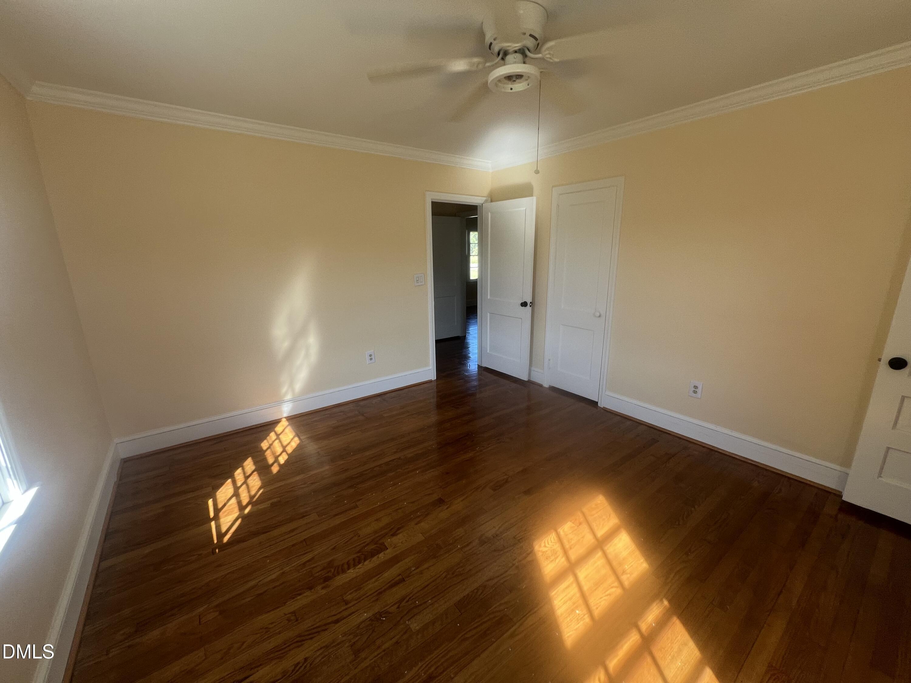 122 Bill Avery Road Coats, NC 27521 - Photo 10 of 51 a view of empty room with wooden floor and fan