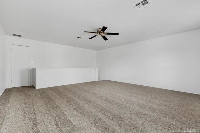 a spacious bathroom with a granite countertop sink a mirror and a shower
