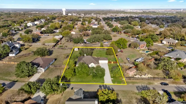 an aerial view of a residential houses with outdoor space