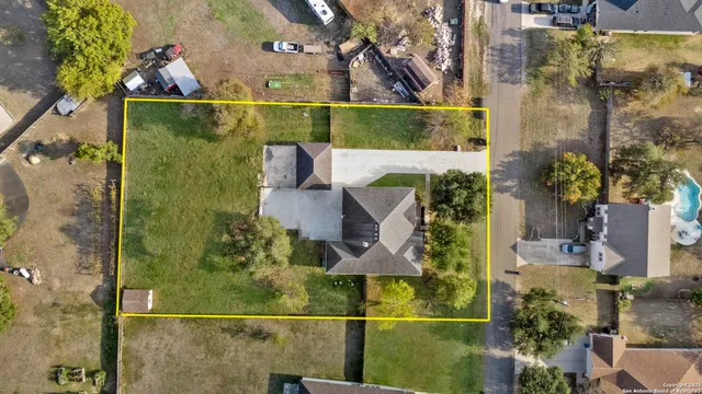 an aerial view of a house with a swimming pool outdoor seating and yard