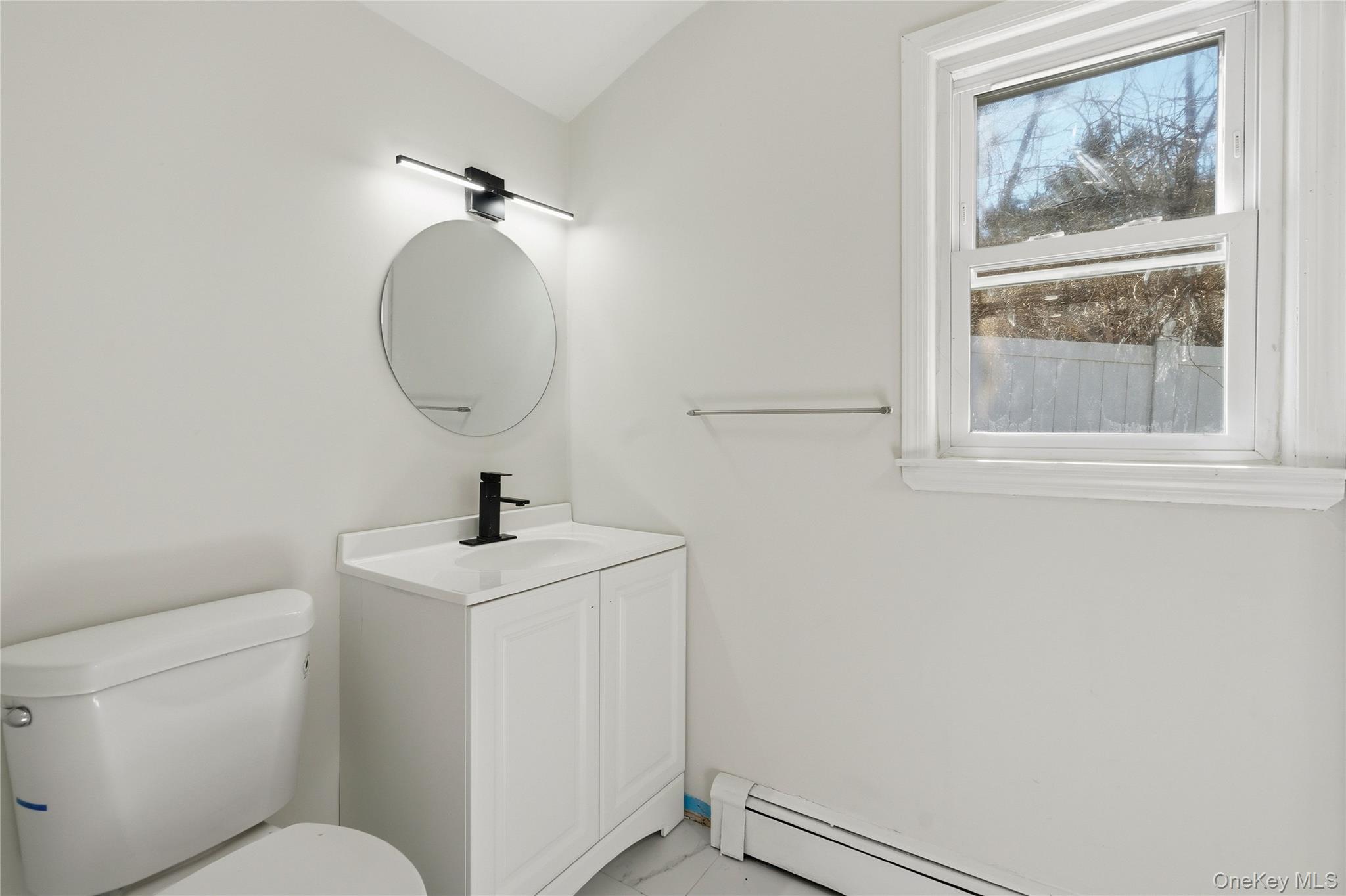 75 Hawthorne Road Kings Park, NY 11754 - Photo 16 of 34 a bathroom with a toilet sink and mirror