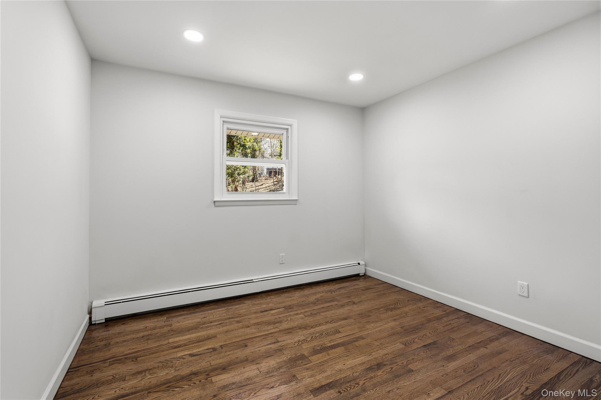 75 Hawthorne Road Kings Park, NY 11754 - Photo 20 of 34 a view of empty room with wooden floor and fan