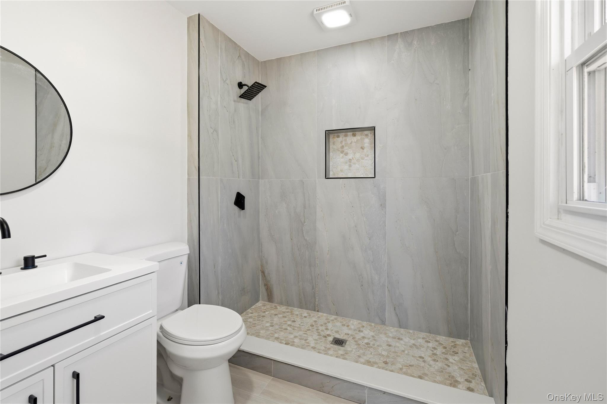 75 Hawthorne Road Kings Park, NY 11754 - Photo 23 of 34 a bathroom with a sink a toilet and shower