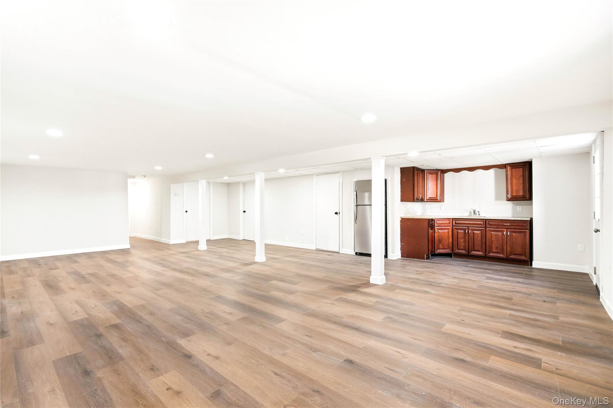 75 Hawthorne Road Kings Park, NY 11754 - Photo 26 of 34 a view of empty room with wooden floor and windows