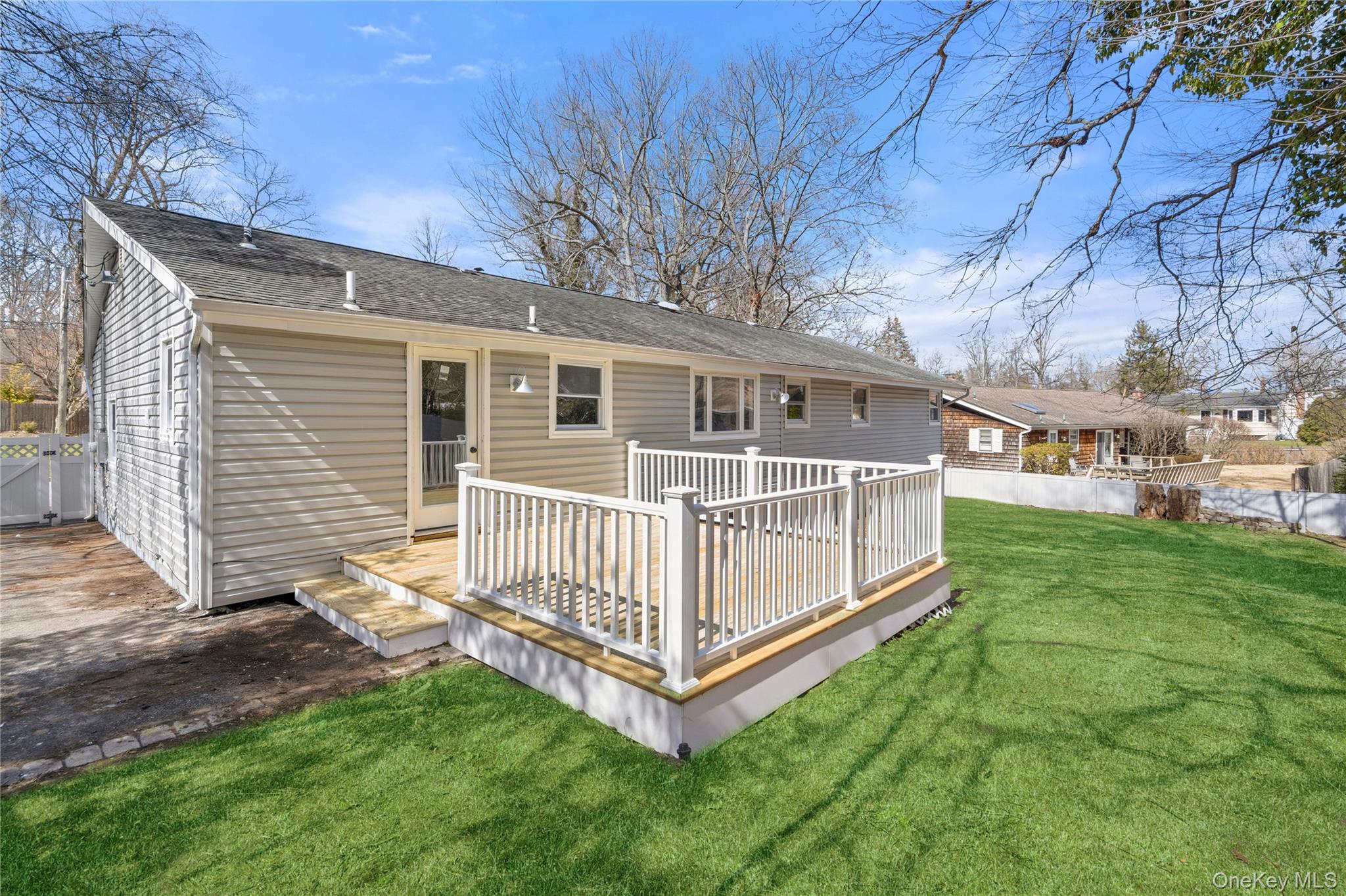 75 Hawthorne Road Kings Park, NY 11754 - Photo 29 of 34 a view of a house with a yard and deck