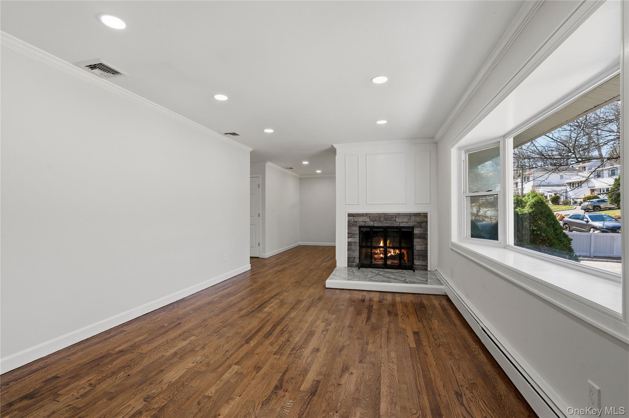 75 Hawthorne Road Kings Park, NY 11754 - Photo 5 of 34 wooden floor in an empty room with a window