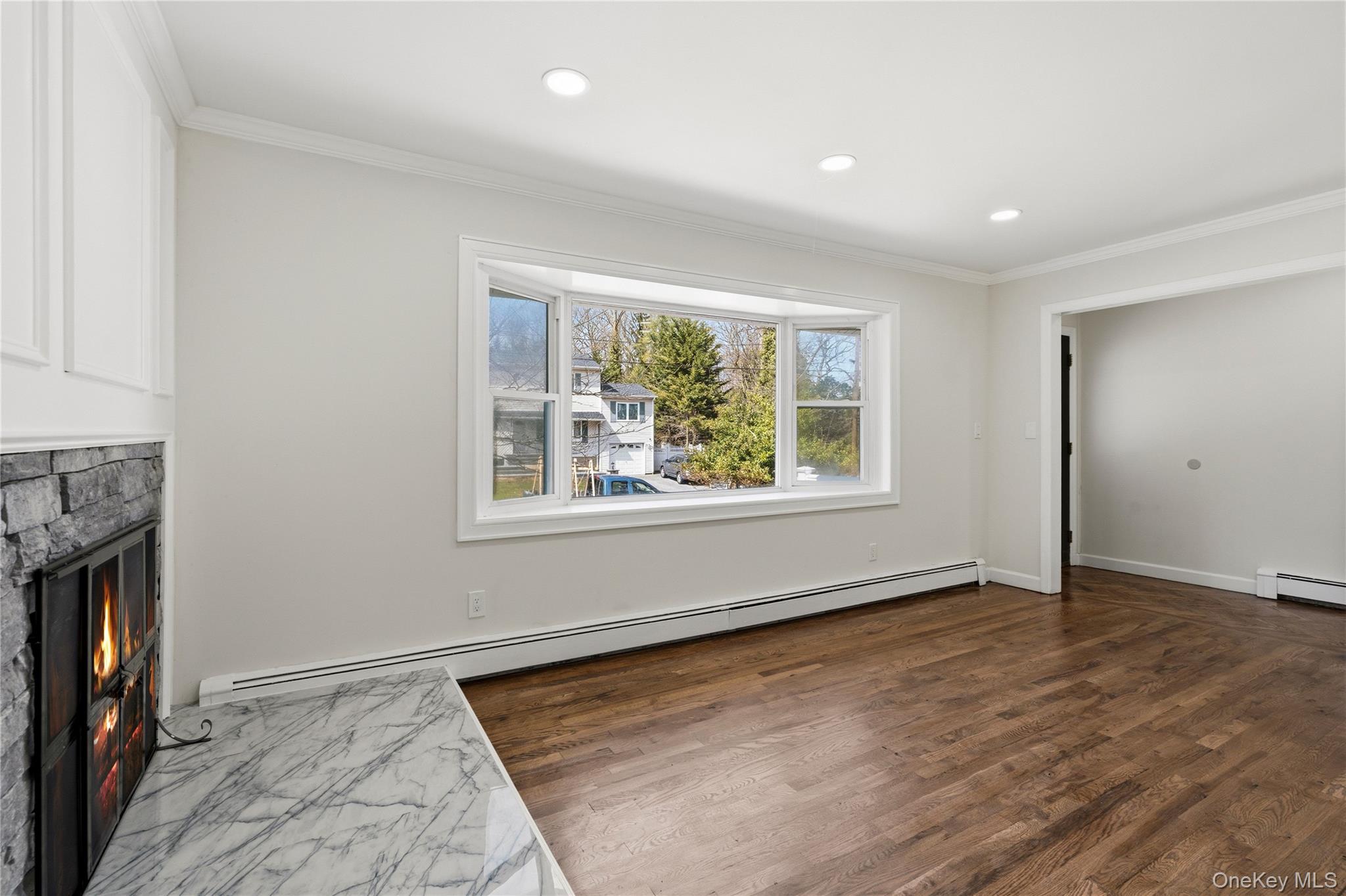 75 Hawthorne Road Kings Park, NY 11754 - Photo 6 of 34 an empty room with windows and fireplace