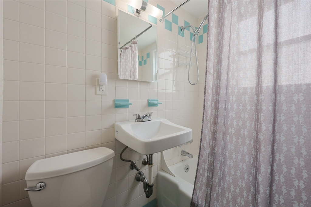 20 Kent Street Saugus, MA 01906 - Photo 13 of 41 a bathroom with a sink a toilet and shower curtain