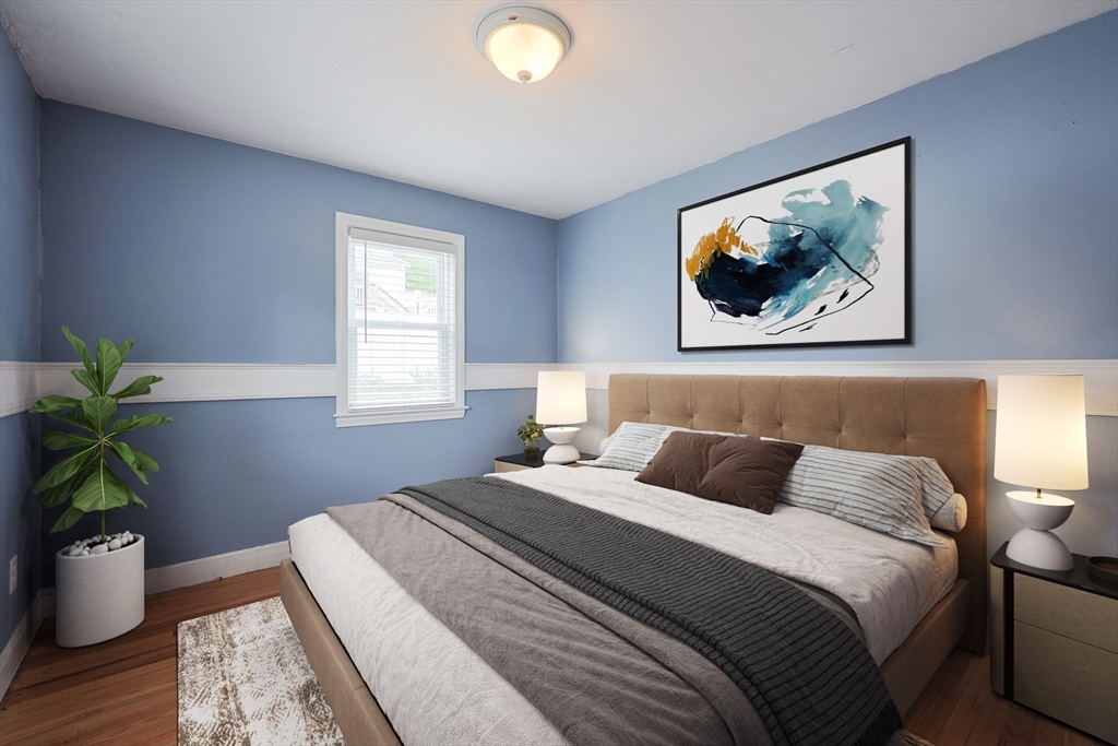 20 Kent Street Saugus, MA 01906 - Photo 17 of 41 a bedroom with a bed and a potted plant