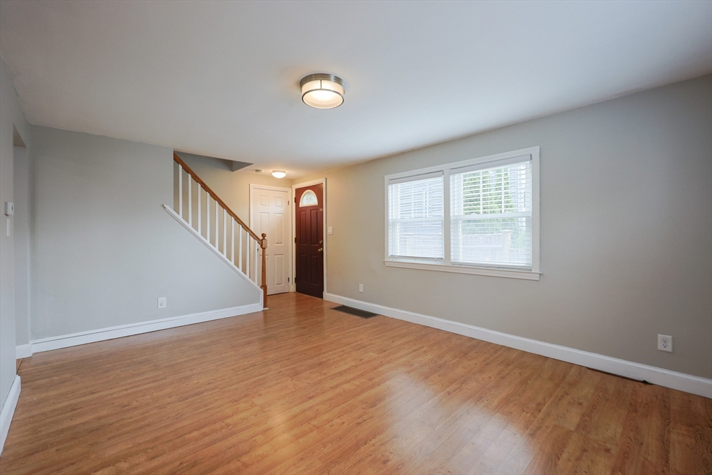 20 Kent Street Saugus, MA 01906 - Photo 27 of 41 a view of an empty room with wooden floor and a window