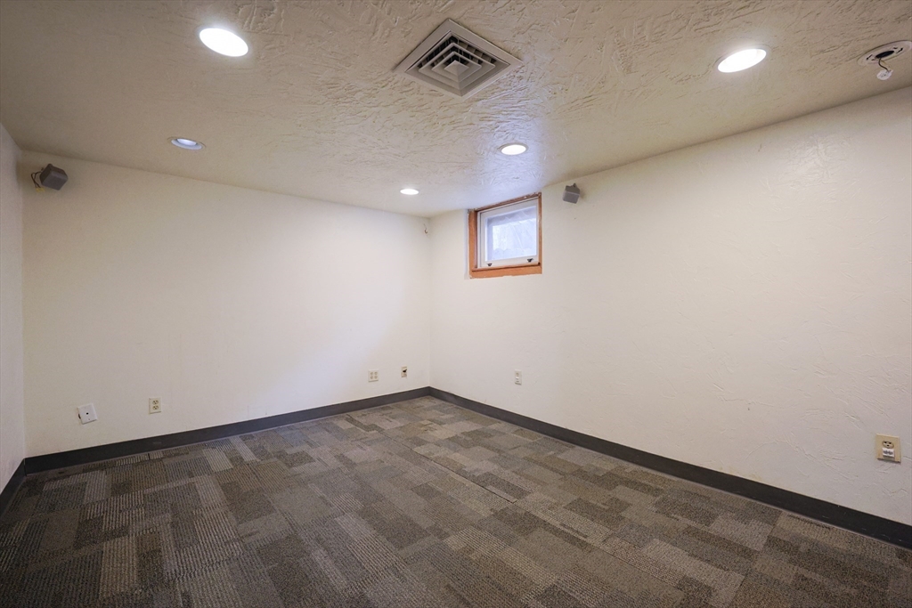 20 Kent Street Saugus, MA 01906 - Photo 31 of 41 an empty room with a ceiling fan and wooden floor