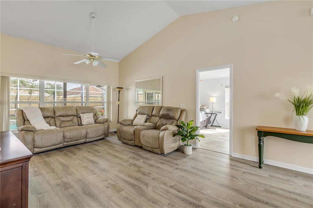 12232 Bronson Way Orlando, FL 32824 - Photo 8 of 32 a living room with furniture and a potted plant