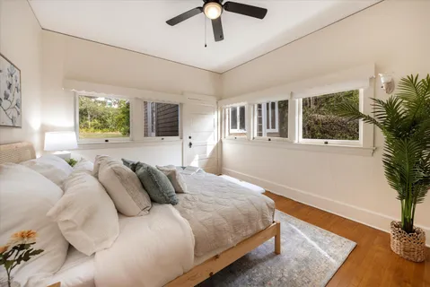 a bedroom with a large bed and a chandelier