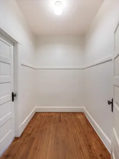 a view of a room with wooden floor