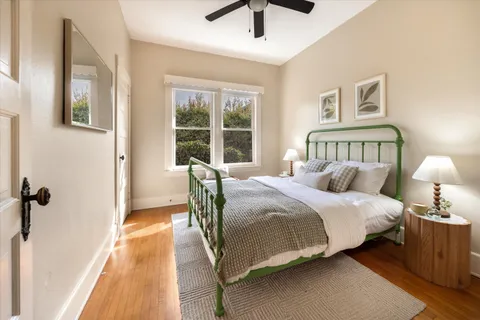 a bedroom with a bed and a lamp on the dresser