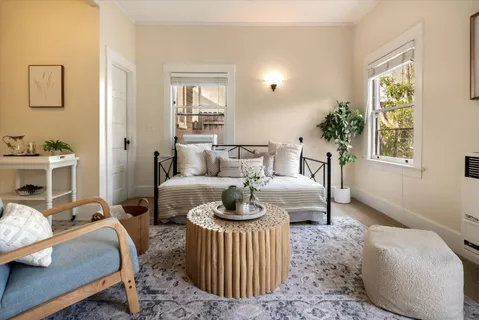 a bedroom with a bed a table and chair