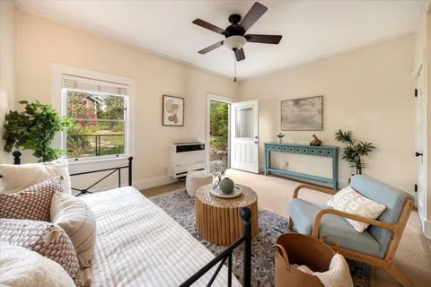 a bedroom with a balcony a bed and a couch