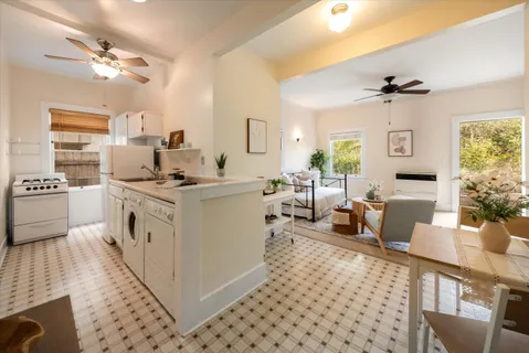 a open kitchen with stainless steel appliances kitchen island granite countertop a sink and a stove