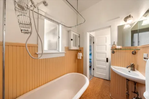 a bathroom with a bathtub and shower