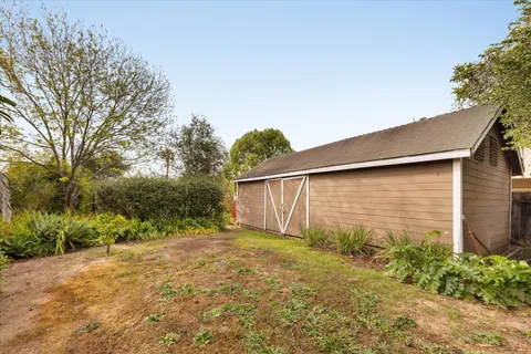 a backyard of a house with plants and trees