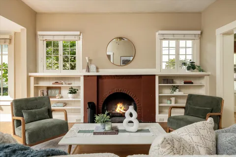 a living room with furniture and a fireplace