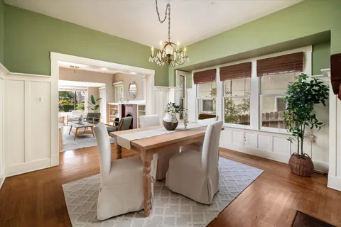 a view of a dining room with furniture wooden floor and chandelier
