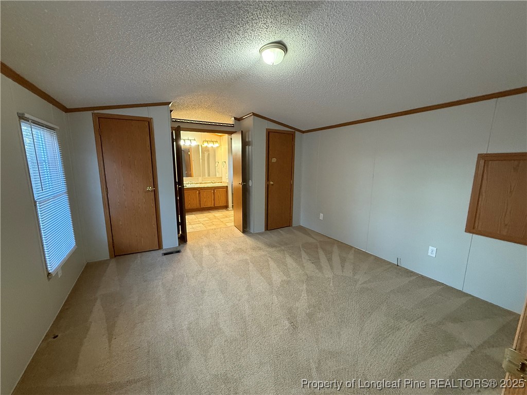 1011 John Godfrey Road Sanford, NC 27332 - Photo 13 of 16 an empty room with closet and mirror