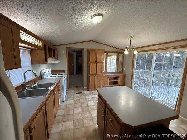 a kitchen with sink and refrigerator