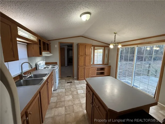 a kitchen with sink and refrigerator