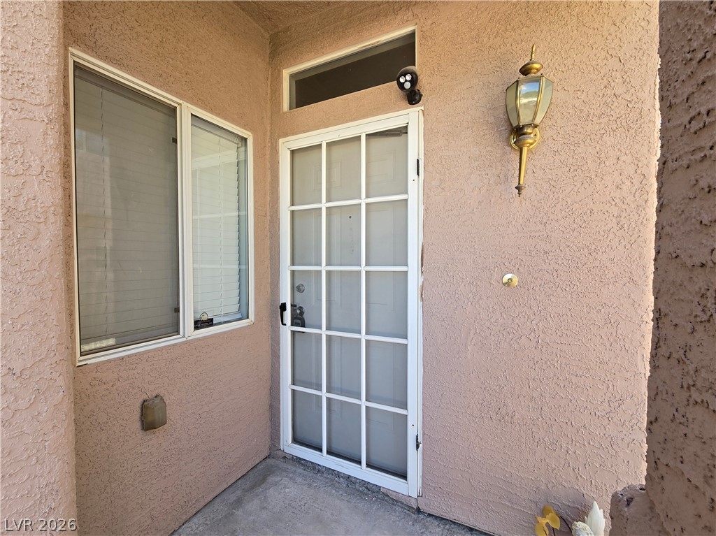 5370 Runningbrook Road Las Vegas, NV 89120 - Photo 5 of 30 Secure entry point with a glass-paneled storm door, offering both protection and curb appeal.