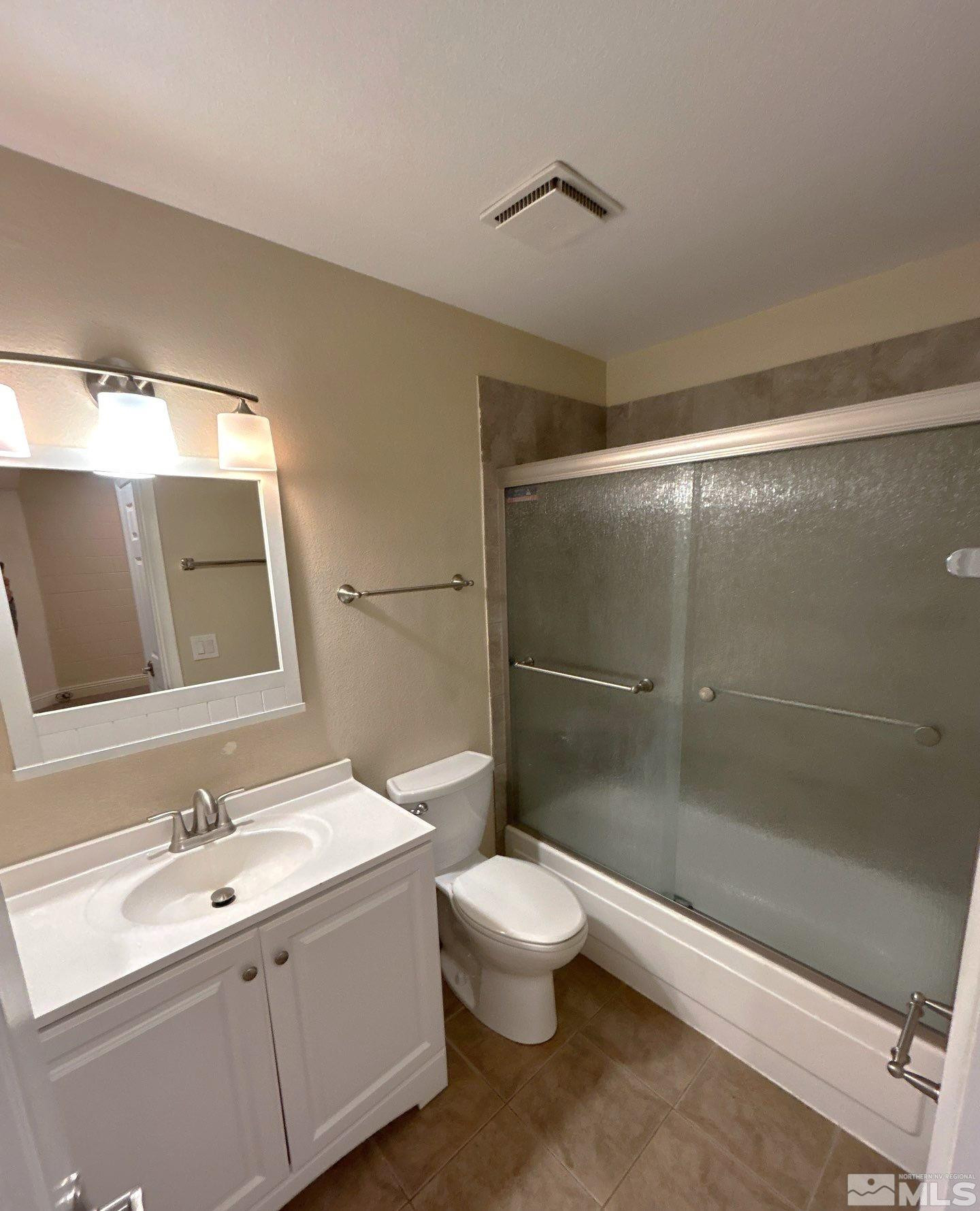 480 Sunshine Lane Reno, NV 89502 - Photo 8 of 11 a bathroom with a double vanity sink toilet and shower