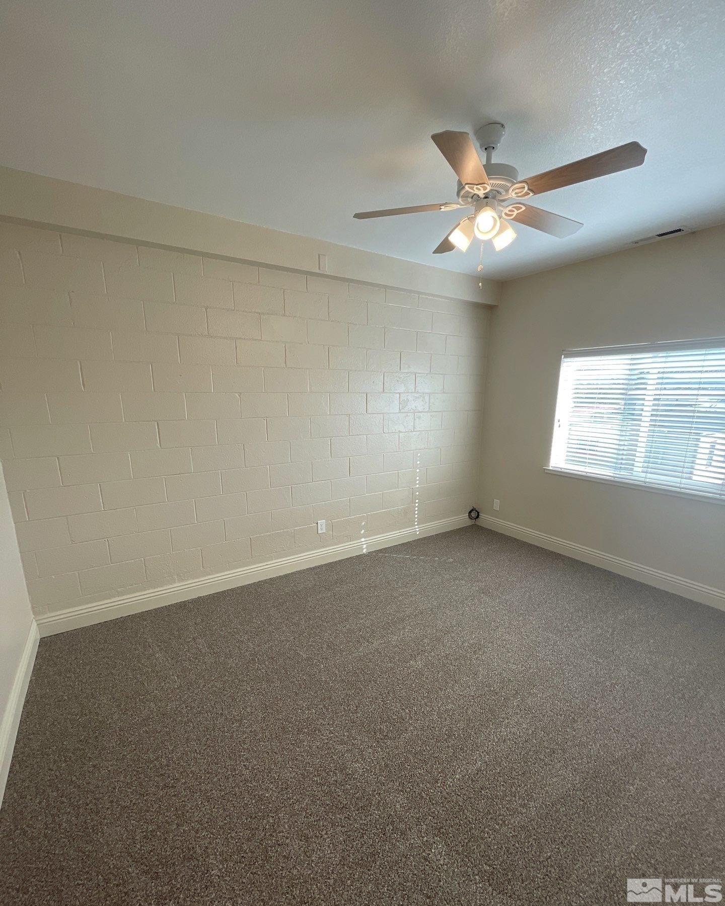 480 Sunshine Lane Reno, NV 89502 - Photo 9 of 11 an empty room with a window and ceiling fan