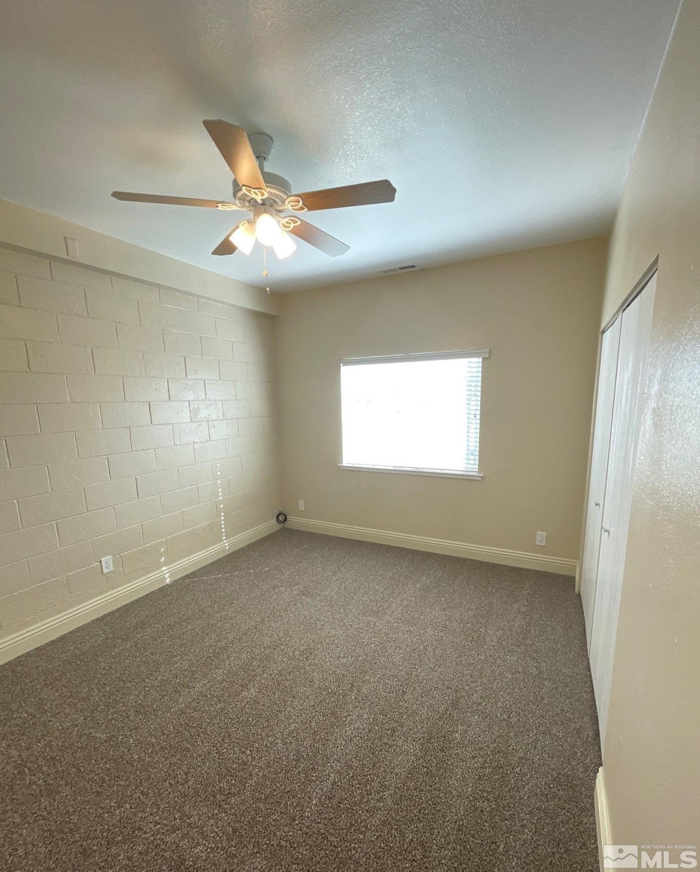480 Sunshine Lane Reno, NV 89502 - Photo 10 of 11 an empty room with windows and fan