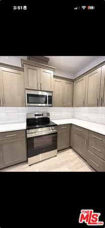 a kitchen with a sink and an oven