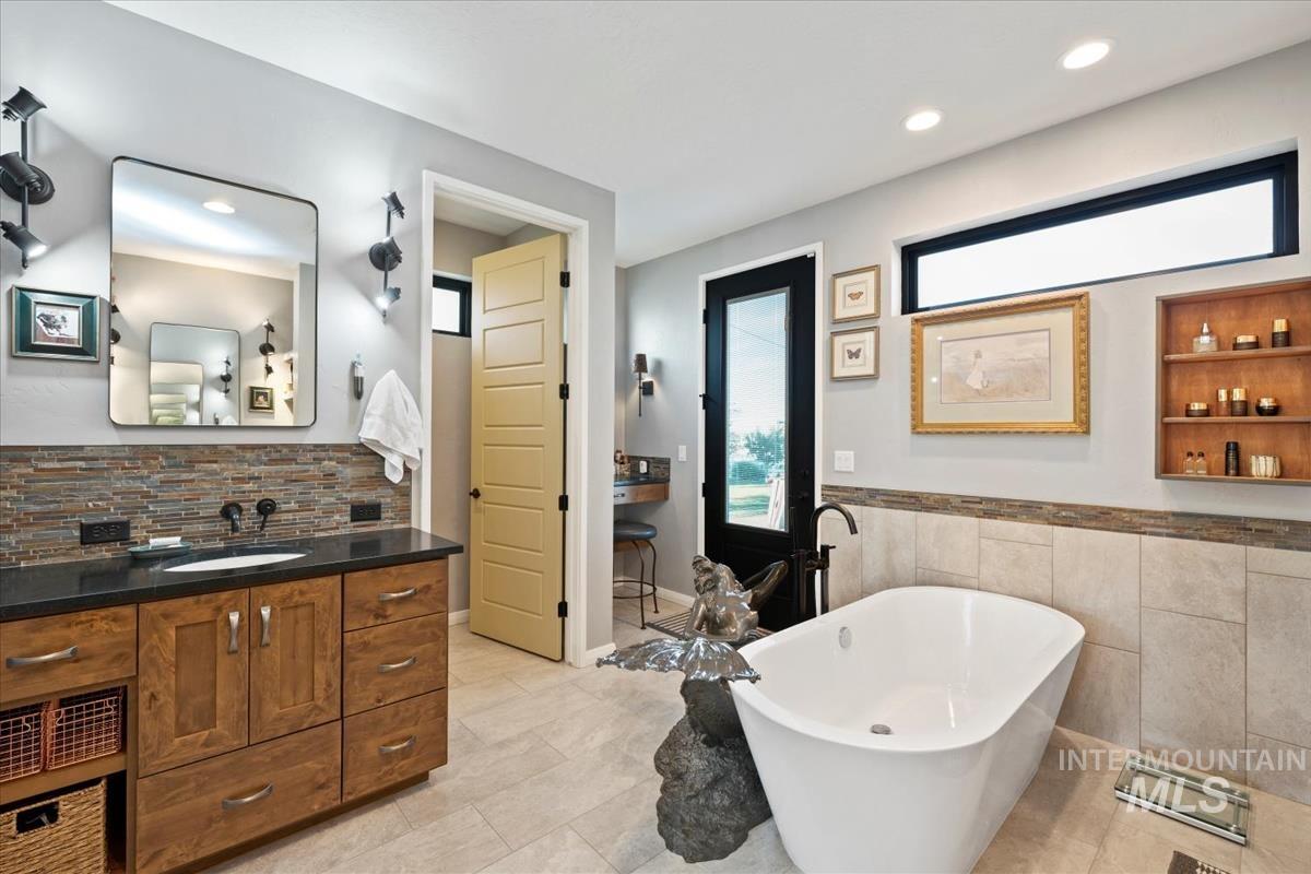 11326 West Rio Road Caldwell, ID 83607 - Photo 19 of 50 Full bath featuring a soaking tub, vanity, recessed lighting, tile walls, and light tile patterned flooring
