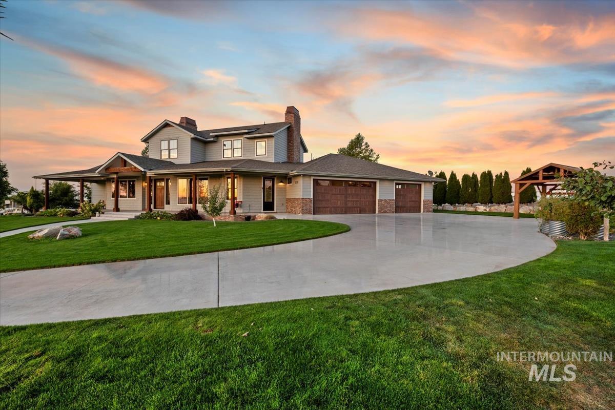 11326 West Rio Road Caldwell, ID 83607 - Photo 2 of 50 View of front of house with a yard, a chimney, a porch, an attached garage, and driveway