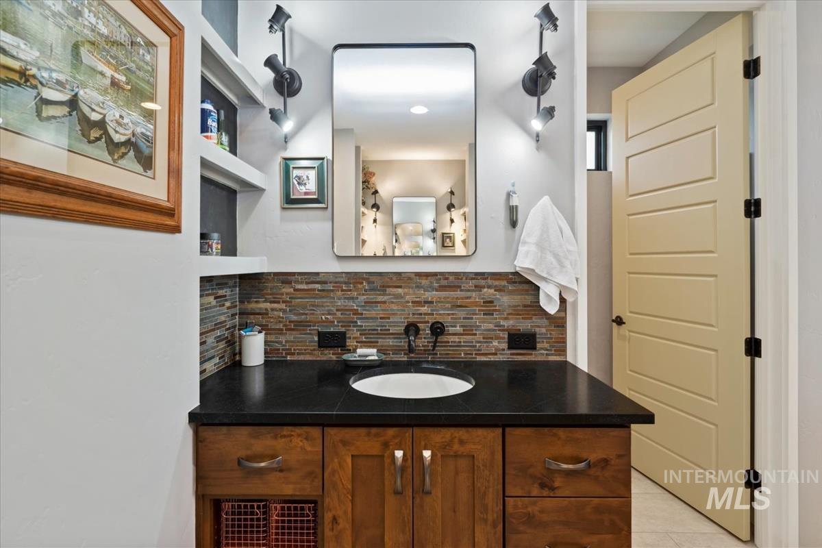 11326 West Rio Road Caldwell, ID 83607 - Photo 20 of 50 Bathroom featuring tasteful backsplash, vanity, and light tile patterned floors