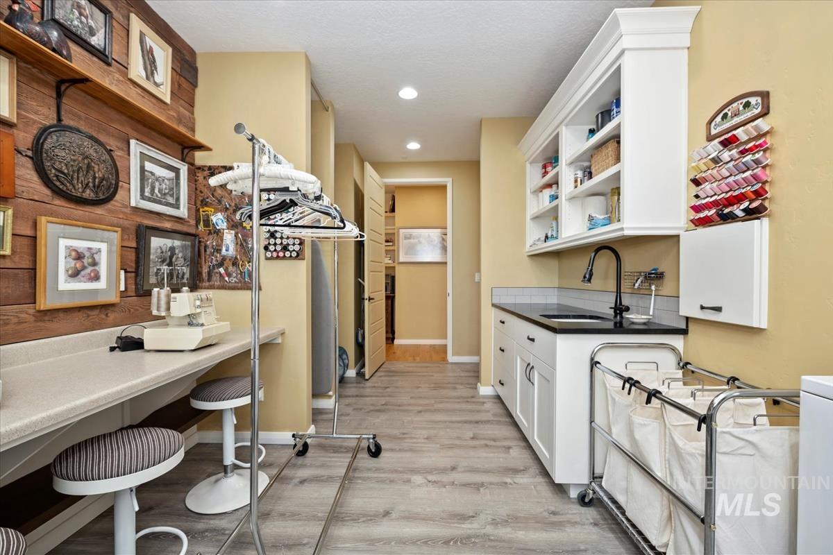 11326 West Rio Road Caldwell, ID 83607 - Photo 22 of 50 Kitchen with light wood-type flooring, dark countertops, white cabinetry, open shelves, and recessed lighting