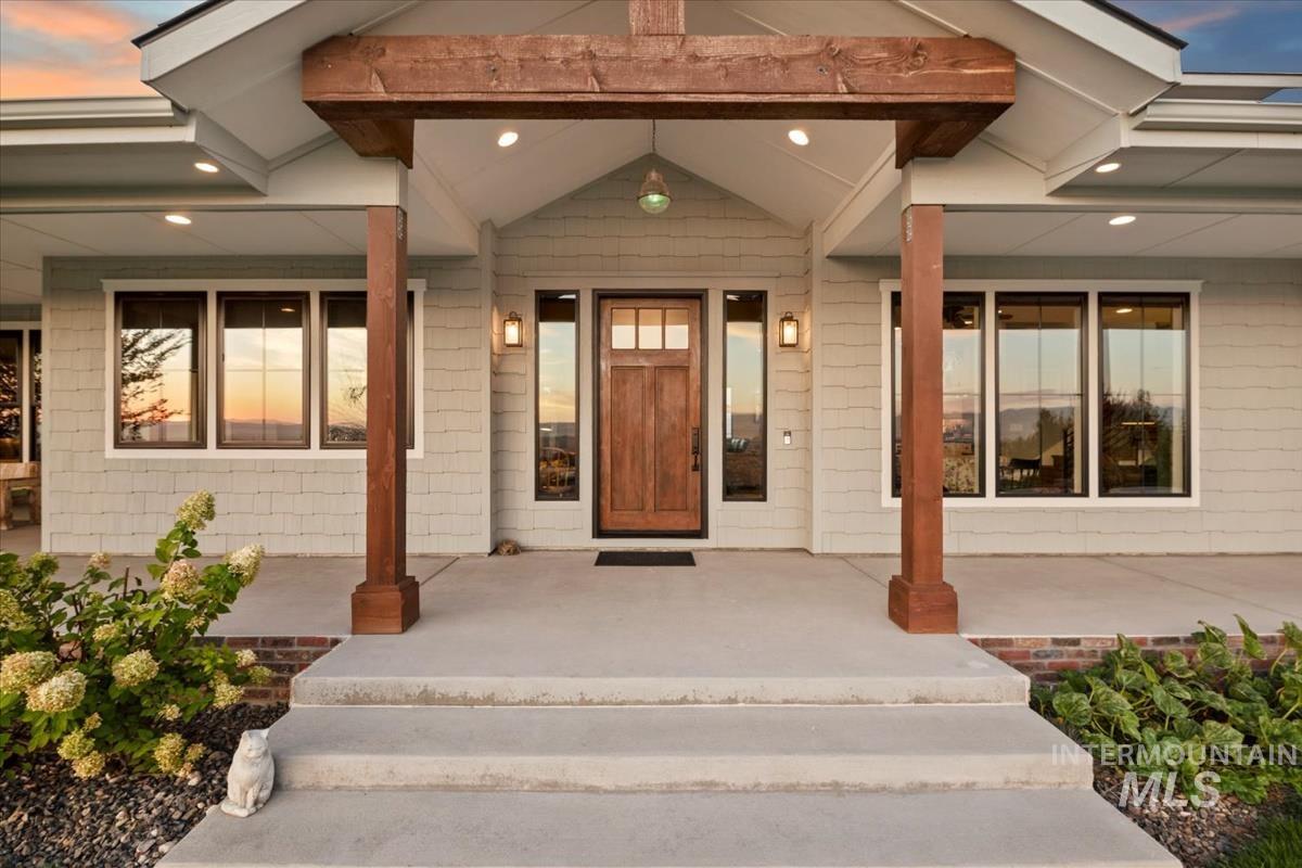 11326 West Rio Road Caldwell, ID 83607 - Photo 4 of 50 Exterior entry at dusk with a porch