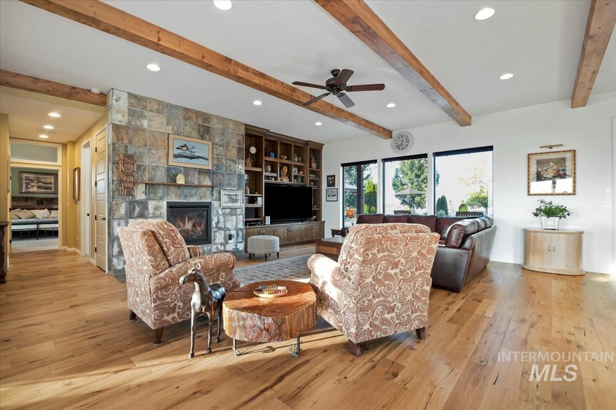 11326 West Rio Road Caldwell, ID 83607 - Photo 8 of 50 Living room featuring recessed lighting, beam ceiling, a tiled fireplace, light wood-style floors, and a ceiling fan