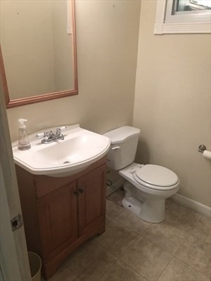 9 Spring Lane Sharon, MA 02067 - Photo 5 of 14 a bathroom with a sink a toilet and a mirror