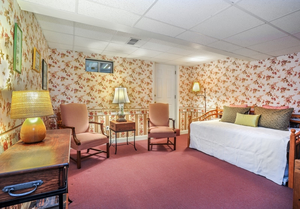 56 Bay Farm Road, Unit 56 Duxbury, MA 02332 - Photo 16 of 20 a bedroom with a bed and a chair