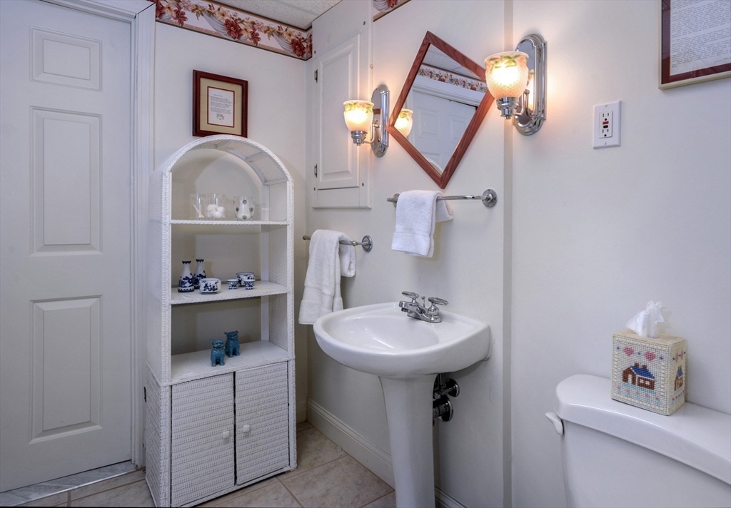 56 Bay Farm Road, Unit 56 Duxbury, MA 02332 - Photo 19 of 20 a bathroom with a toilet a sink and a mirror
