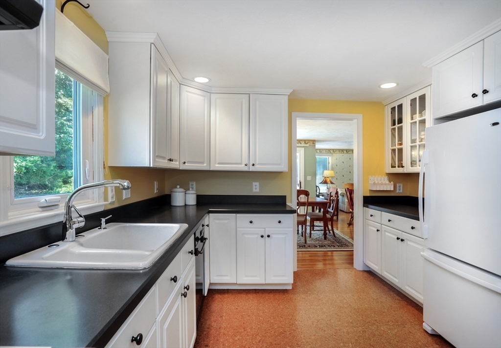 56 Bay Farm Road, Unit 56 Duxbury, MA 02332 - Photo 8 of 20 a kitchen with a sink a counter top space and appliances